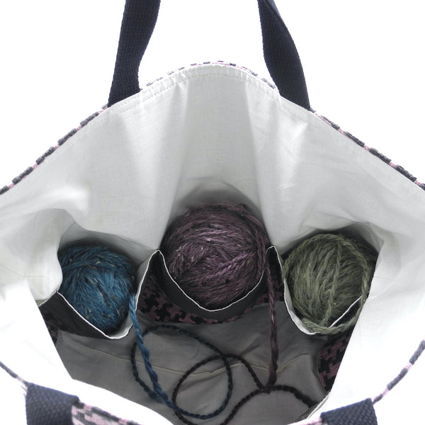 Inside colour work basket showing pockets with yarn