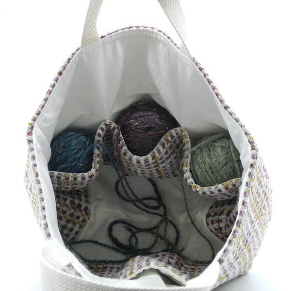 inside project bag showing pockets with yarn