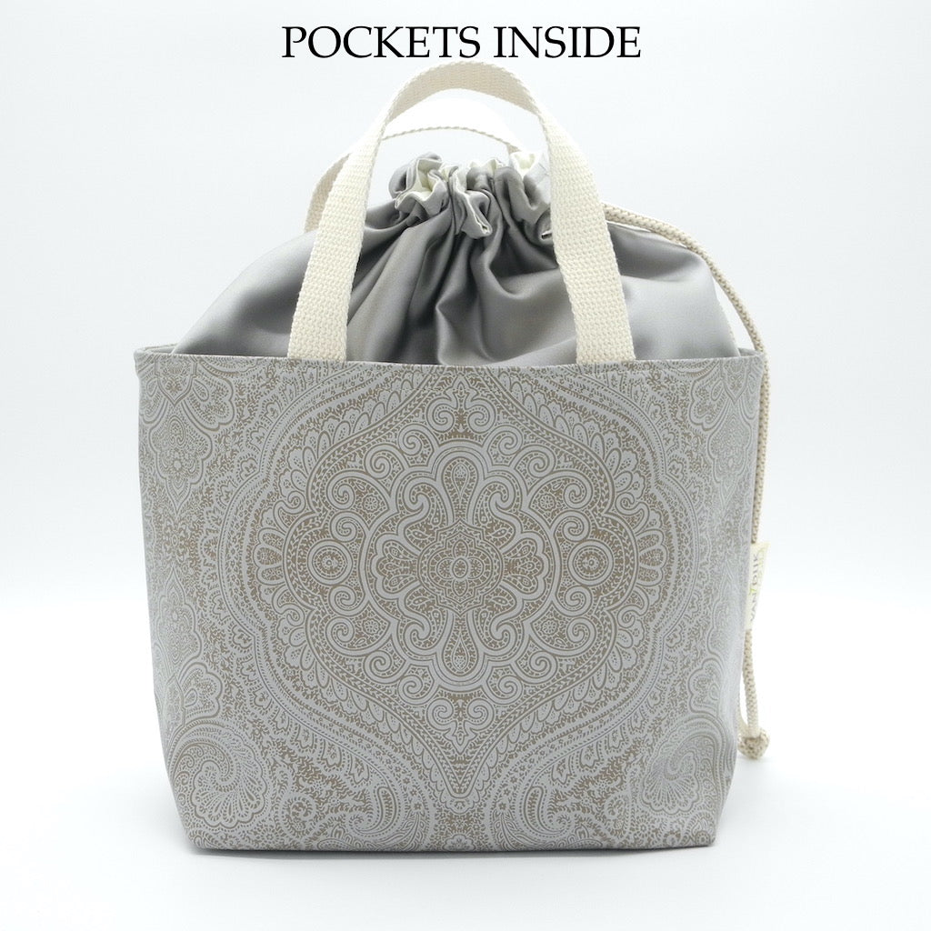 drawstring basket front view with words pockets inside