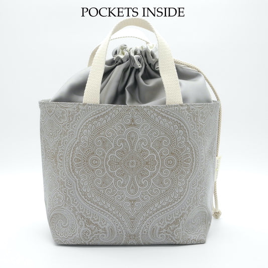 drawstring basket front view with words pockets inside