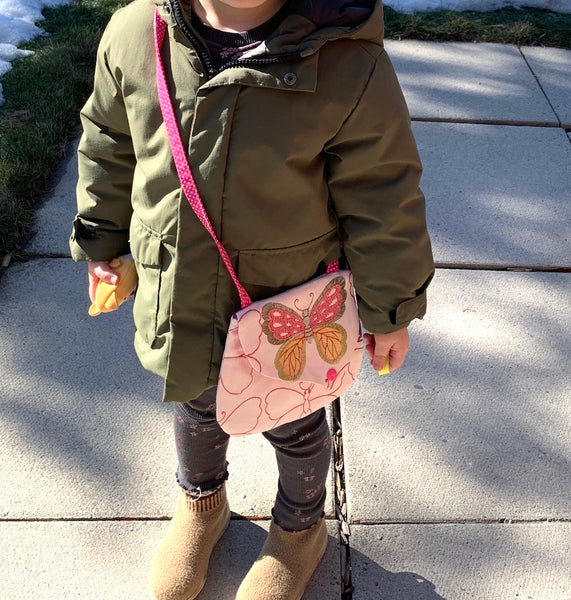 child wearing purse